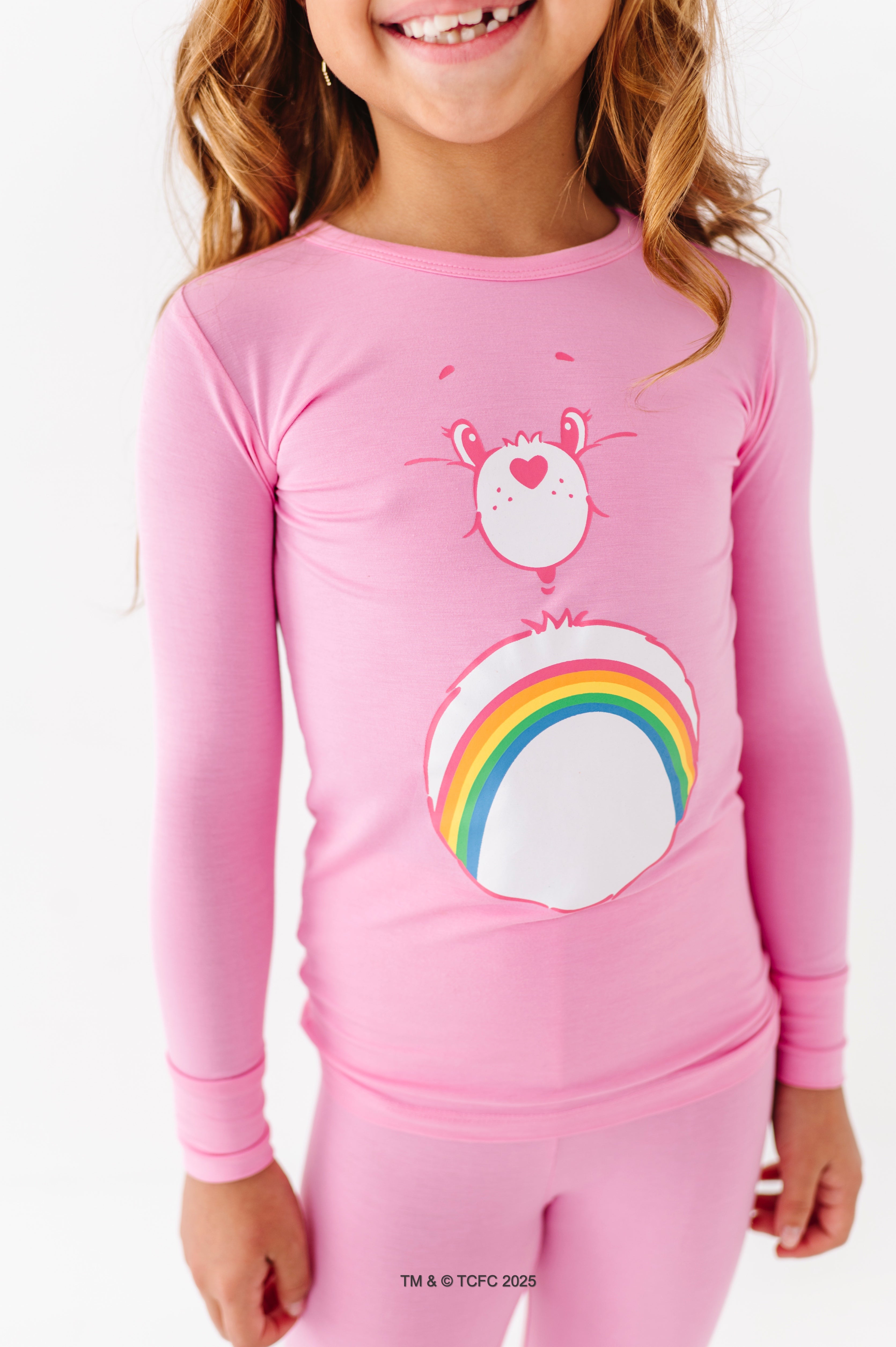 Close-up of Care Bears Cheer Bear long sleeve pajama top with rainbow graphic
